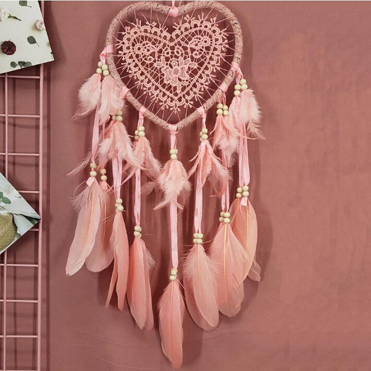Heart-shaped dream catcher wall hanging with pink beaded tassels and feather streamers