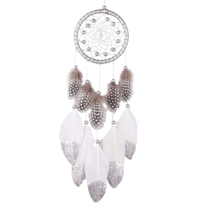 White dreamcatcher wall hanging with silver web and dangling white and sparkly feather charms