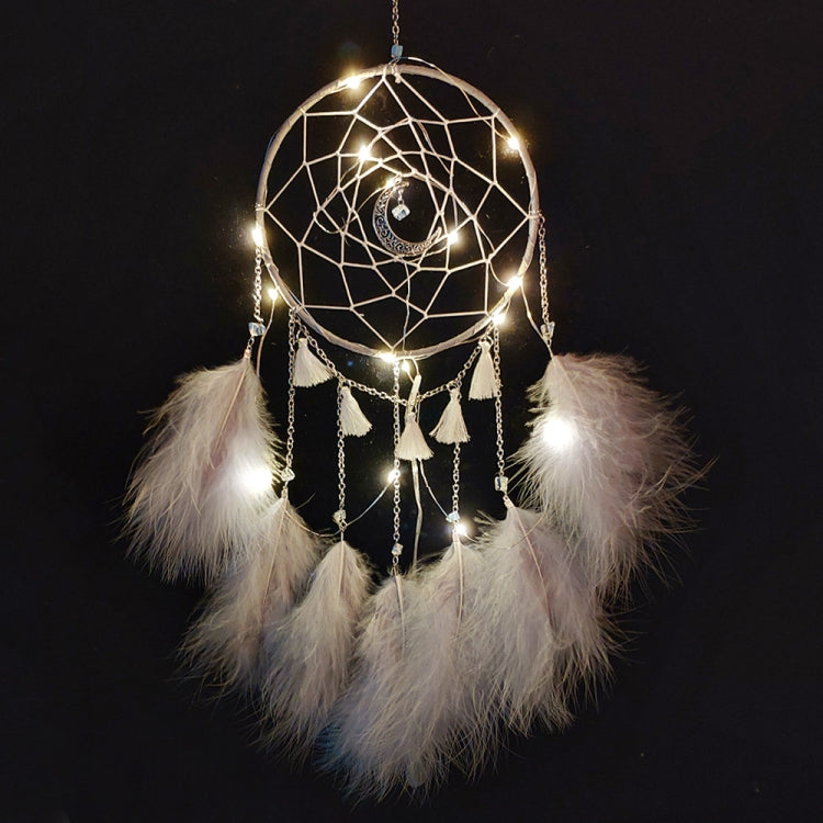 White dream catcher wall hanging with hoop web, dangling tassels, and feather clusters, lights on
