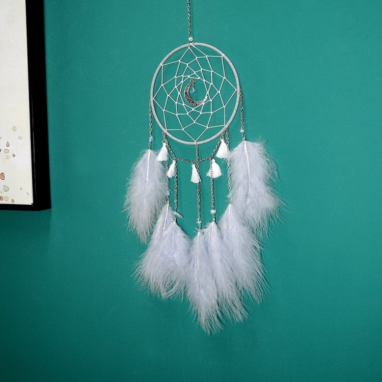 Green hoop dream catcher wall hanging with white feathers, small tassels, and dangling chain details