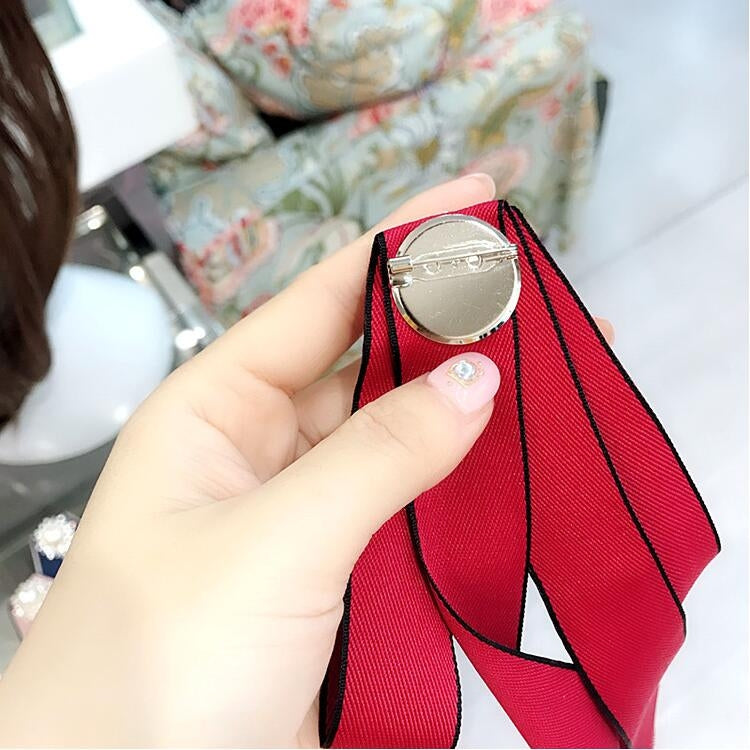 Red wine pearl rhinestone bow-knot brooch with round faux pearl center and dangling ribbons