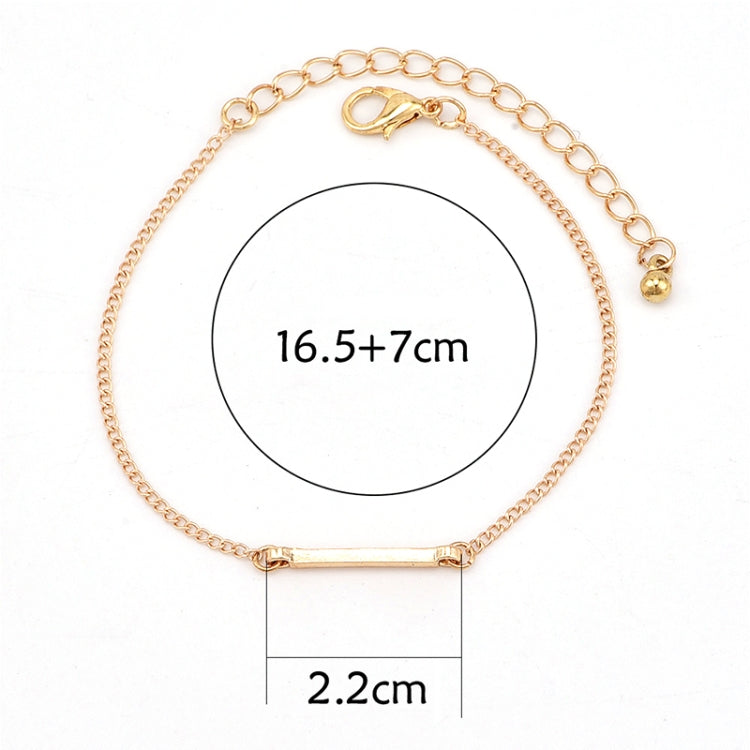 Gold-tone chain bracelet with oval ring center and bar clasp, measured flat lay