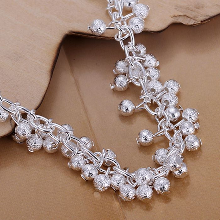 Silver-plated grape charm bracelet with ball clusters and chain links, lobster clasp