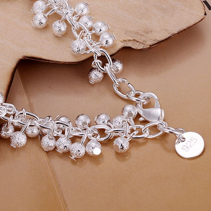 Silver-plated grape charm bracelet with dangling ball beads and round 925 coin tag