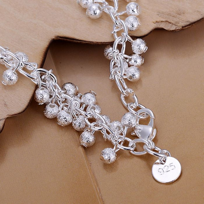Silver-plated grape charm bracelet with heart connector charm and 925 coin tag