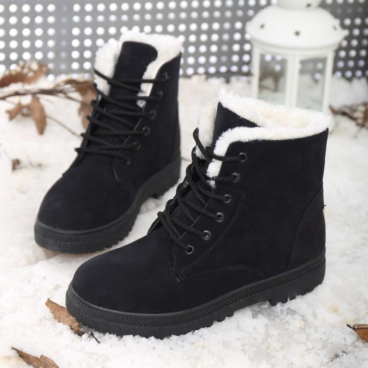 Ladies black lace-up snow boots with white faux-fur trim and rubber sole