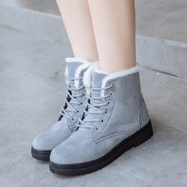 Women’s gray lace-up snow boots with plush white trim and dark rubber sole