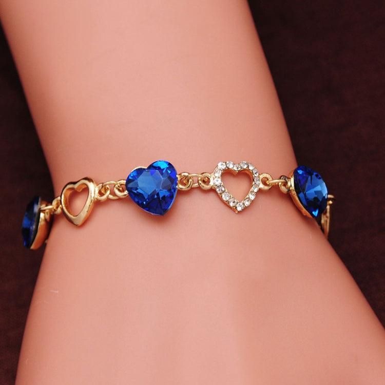 Blue crystal heart charm bracelet with rhinestone heart center on wrist
