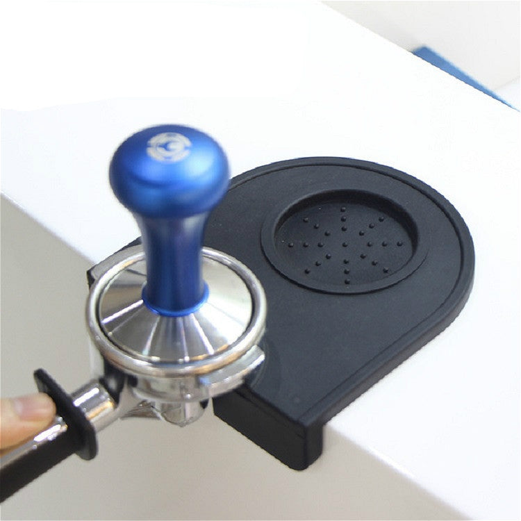 Black corner coffee pad with raised round textured insert for filling at sink corner.