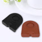 Two corner coffee pads, black and brown/orange, each with embossed round textured center.