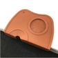 Brown/orange corner coffee pad close-up with round embossed textured insert and front notch.