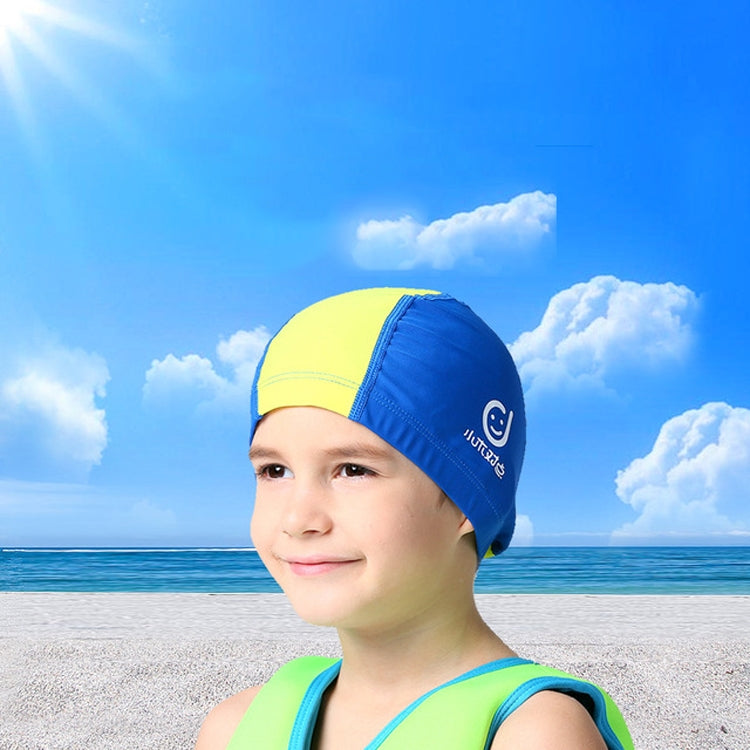 Kids' sun-protective swim cap on child in yellow with blue side panels and logo