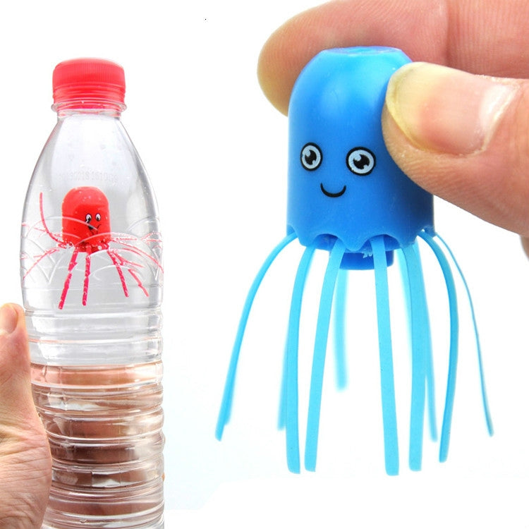 Blue plastic jellyfish toy with smiling face and tentacles, held in a hand.