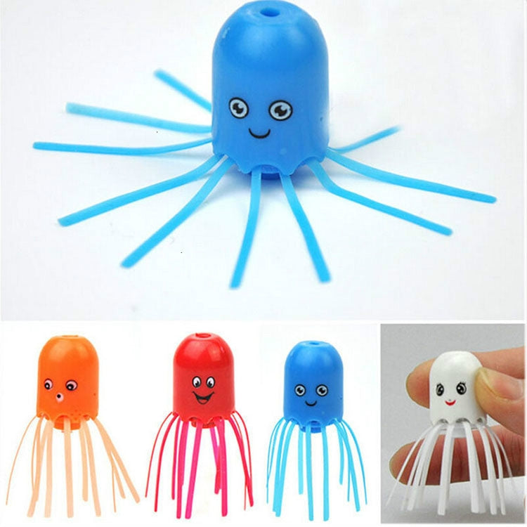 Blue jellyfish toy with smiling eyes and long thin tentacles, standing upright.