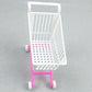 Doll shopping cart toy with white basket and pink frame, four small caster wheels