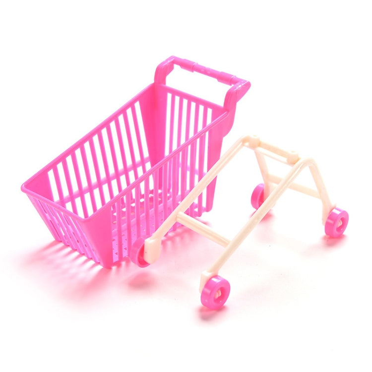 Doll shopping cart toy with pink basket, beige frame, and four pink caster wheels
