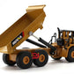 Tan alloy articulated dump truck toy with tipping bed raised and cab detail visible