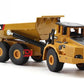 Tan alloy articulated dump truck toy with front grille, black cab, and raised bed