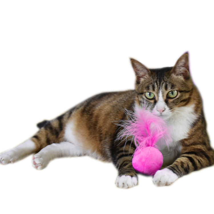 Plush cat toy with pink bell pom and feather tuft, shown with a resting cat