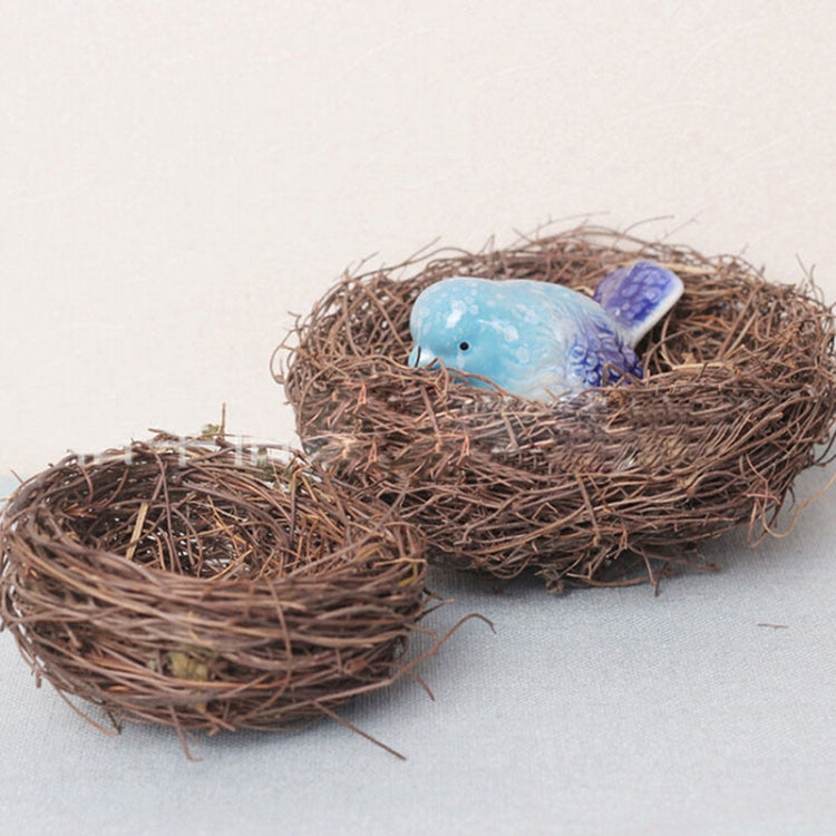 Brown rattan bird nest with blue bird figurine and woven nest eggs
