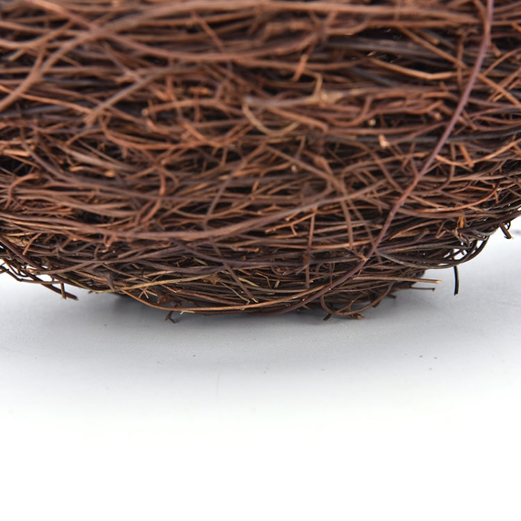 Close-up of brown woven rattan nest bowl with loose straw fibers