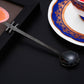 Black guitar-shaped stainless steel coffee mixing spoon with long, angled handle