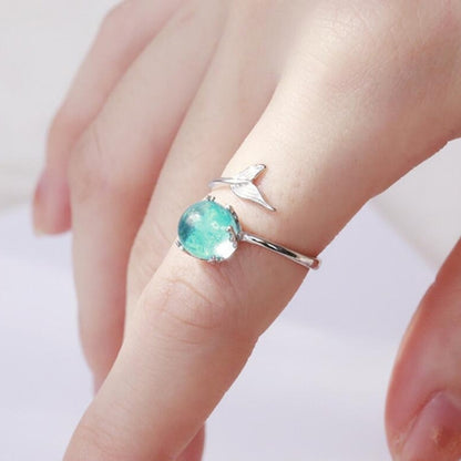 Silver open ring with round turquoise crystal and small fish-tail charm