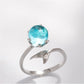 Silver open ring featuring a large round turquoise gemstone and fish-tail detail