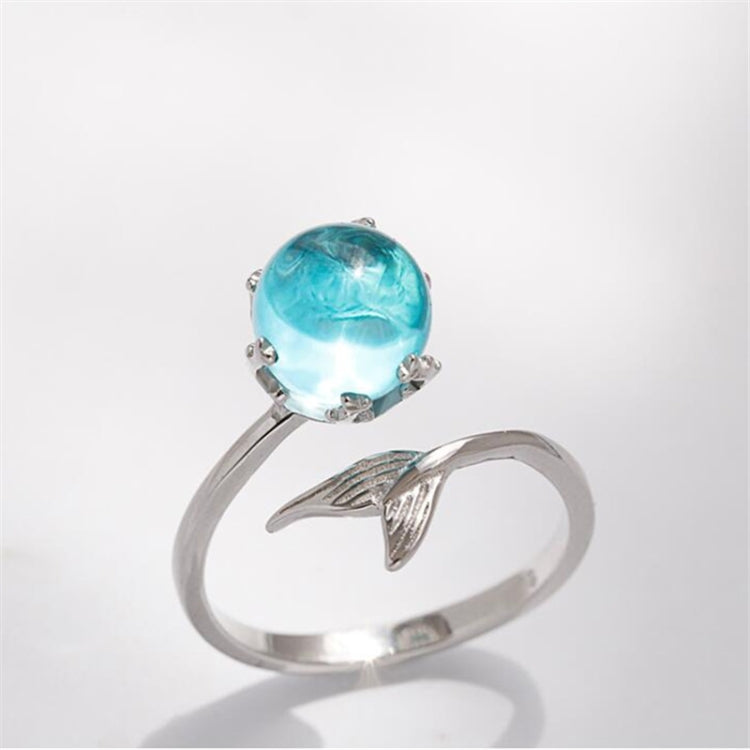 Silver open ring featuring a large round turquoise gemstone and fish-tail detail