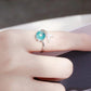 Turquoise crystal open ring with small fish-tail charm on the band