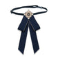 Navy cloth bow-knot tie with pearl flower center, long tails on black neck strap