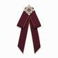 Maroon cloth bow-knot accessory with pearl flower center and long ribbon tails