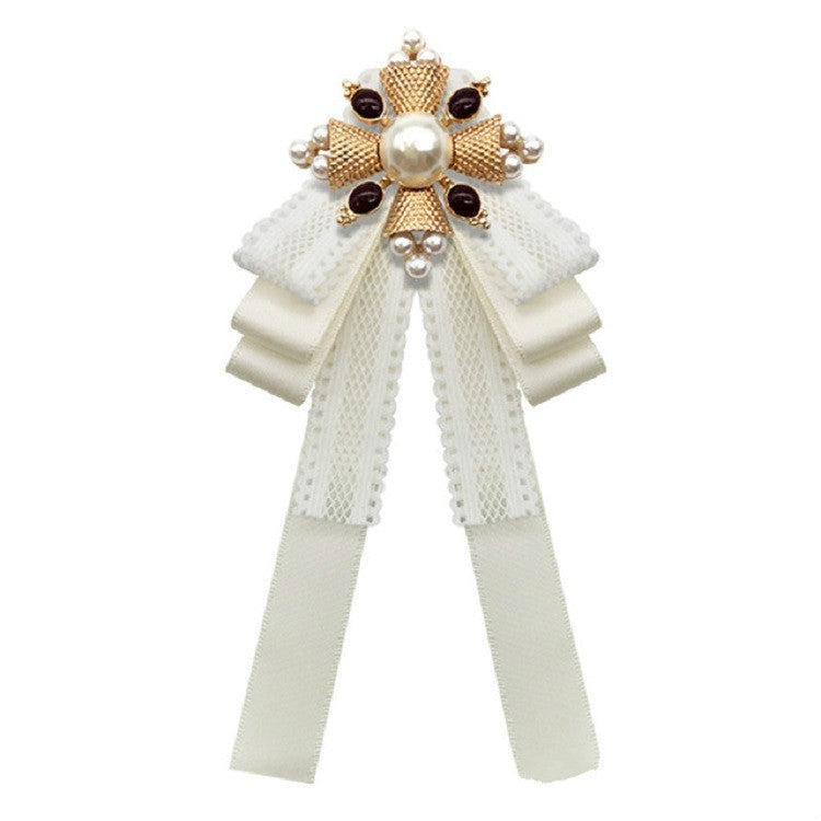 White lace bow accessory pin with large pearl centerpiece and layered ribbon bows