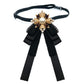 Black lace bow accessory on a choker strap with pearl centerpiece and ribbon streamers