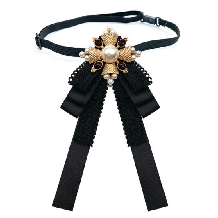 Black lace bow accessory on a choker strap with pearl centerpiece and ribbon streamers