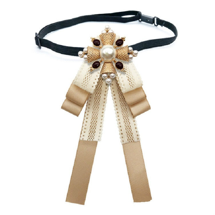 Champagne lace bow accessory on a dark choker strap with pearl centerpiece and ribbons