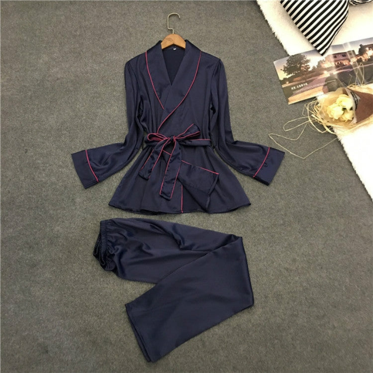 Silk-look navy pajama set with robe-style top, red trim, and matching drawstring pants