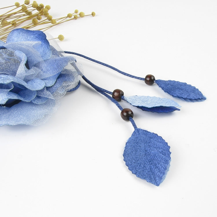 Blue tassel belt detail with three leaf charms and brown bead knots