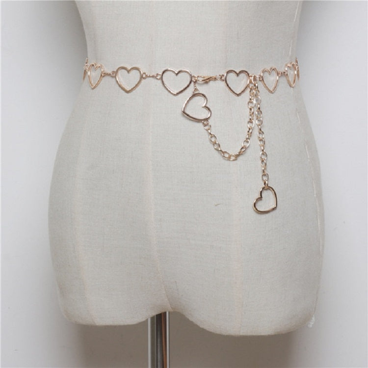 Gold-tone heart link waist chain with dangling heart charms on a belt