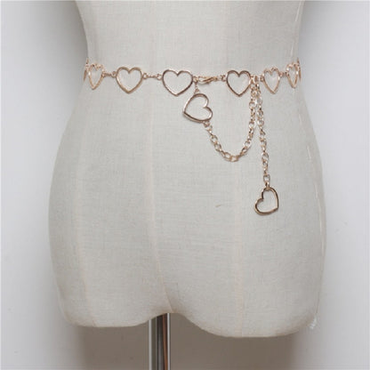 Gold-tone heart link waist chain with dangling heart charms on a belt