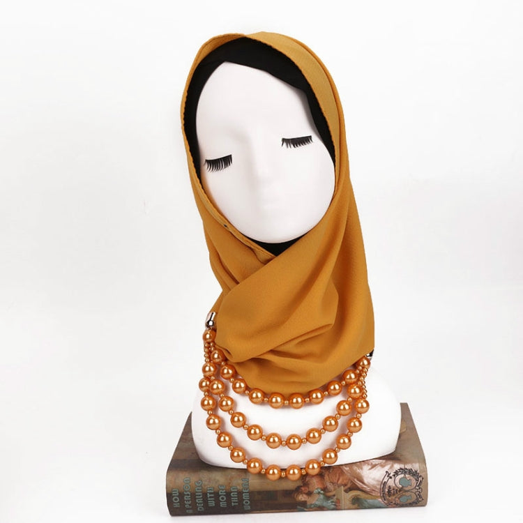 Mustard-gold scarf with copper-gold imitation pearl necklace, layered bead strings