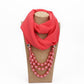 Red scarf with imitation pearl bead necklace, layered pink-red beads at the neckline.
