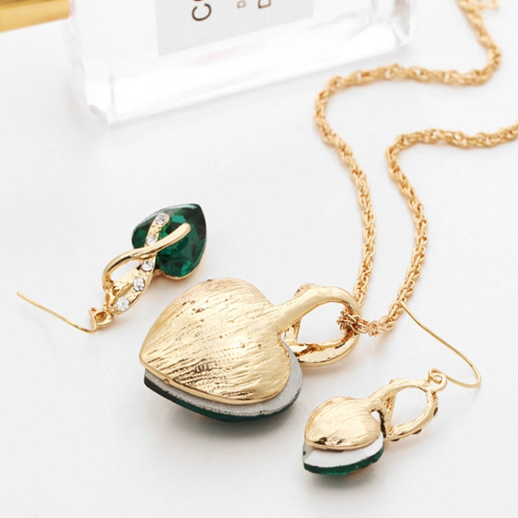 Gold-tone heart jewelry set with green heart pendant necklace and matching drop earrings