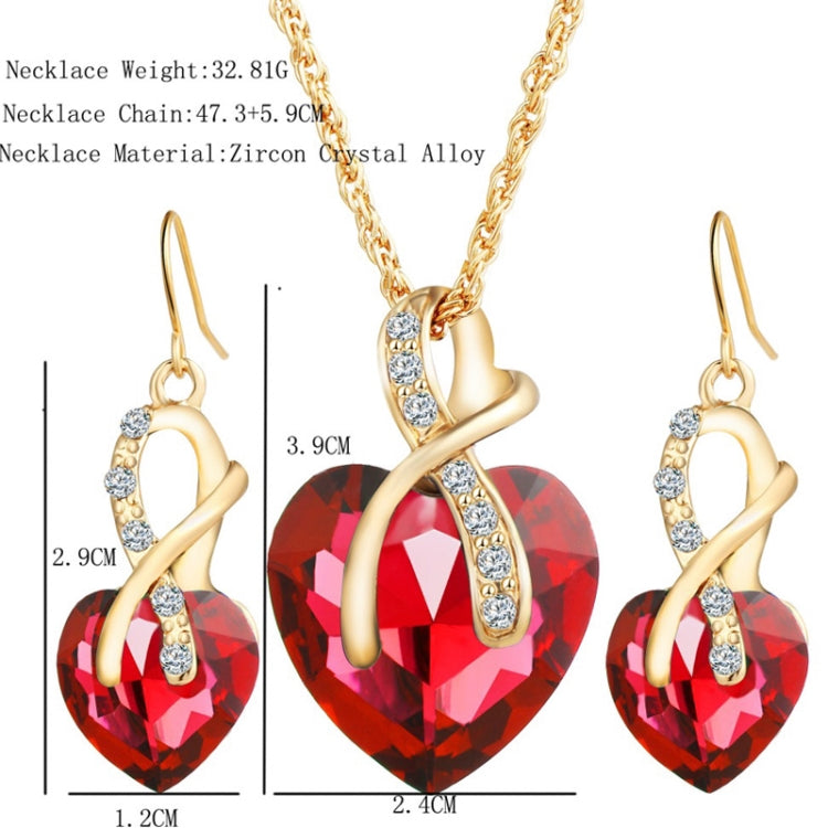 Gold-tone heart jewelry set with red crystal heart pendant necklace and matching drop earrings