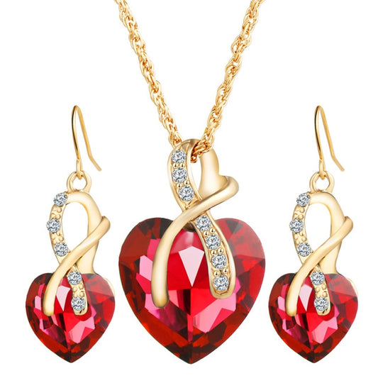 Gold-tone heart jewelry set with red heart pendant necklace and matching drop earrings