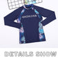 Navy long-sleeve swim top with raised collar and tropical side stripe panels