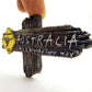 Kangaroo Australia fridge magnet close-up, dark wooden cross sign with yellow icon
