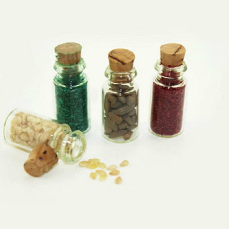 Mini glass food bottle set with corks, green, tan, and red contents