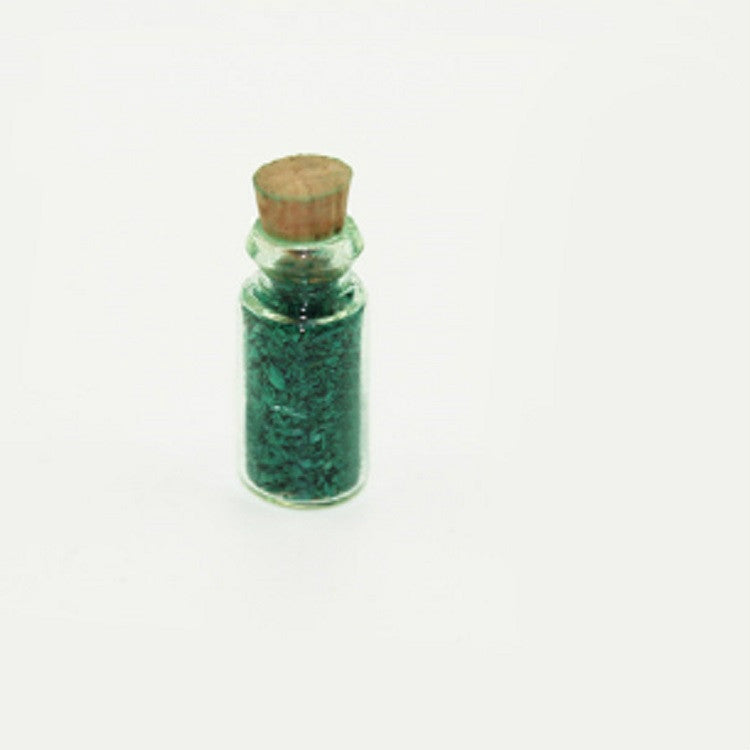 Mini glass food bottle with cork, clear body filled with green granules