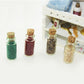 Mini glass food bottles with corks displayed in a dollhouse kitchen set